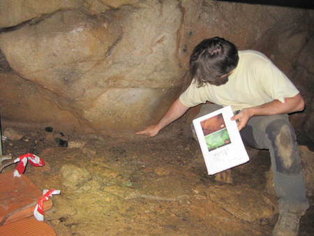 Arquelogo da USC mostrando as pinturas rupestres da Cova